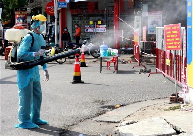 A street in central Quảng Ngãi Province is disinfected after reporting 13 new cases on Wednesday. — VNA/VNA Photo Lê Ngọc Phước