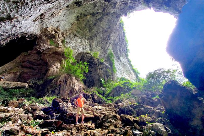 An explorer poses for a photo in a cave in Ngu Lao limestone mountainous area