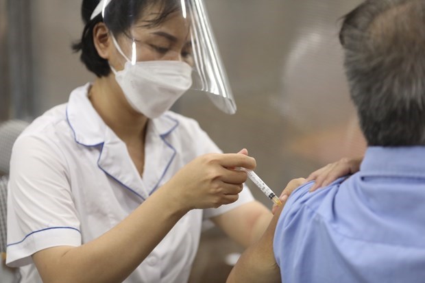A medic injects a COVID-19 vaccine shot to a citizen.