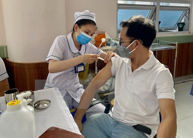 A health worker administers COVID-19 vaccine.