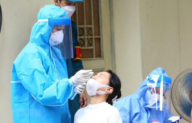 A resident in Hanoi has sample taken for COVID-19 testing.