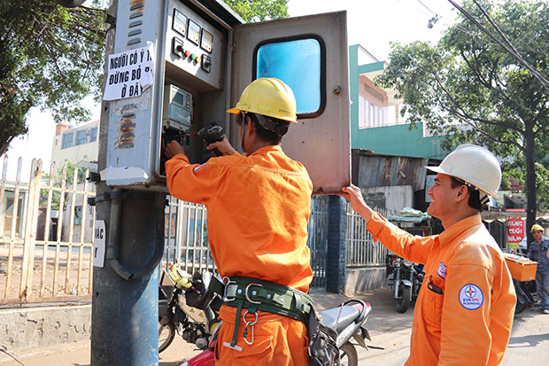 Công nhân Điện lực Biên Hòa 2 thay đồng hồ tăng công suất trạm công cộng, đảm bảo cung cấp điện cho người dân.