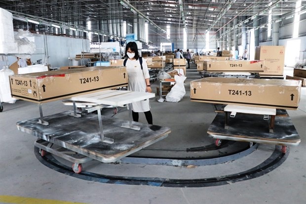 Packing line at Trieu Phu Loc Furniture Co in Binh Duong province. The Government, localities and businesses are rushing to put the economy back on track. (Photo: VNA)