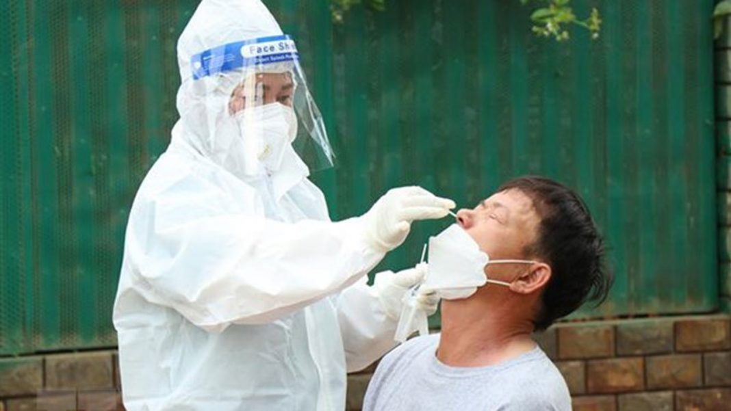 A medical worker swabs a man for Covid testing – PHOTO: VNA