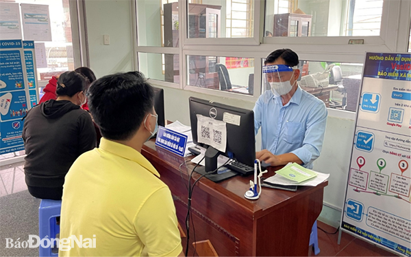 Cán bộ phòng Truyền thông và Phát triển đối tượng, BHXH tỉnh Đồng Nai hướng dẫn người lao động cài đặt ứng dụng “VssID - BHXH số”