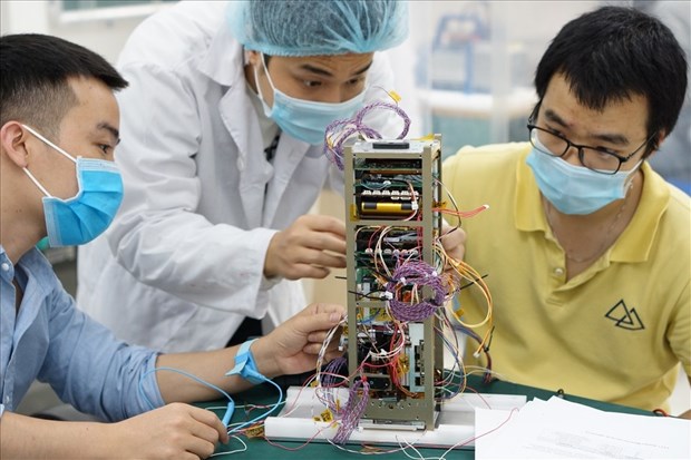 Scientists from the Vietnam National Space Centre manufacturing NanoDragon satellite. 