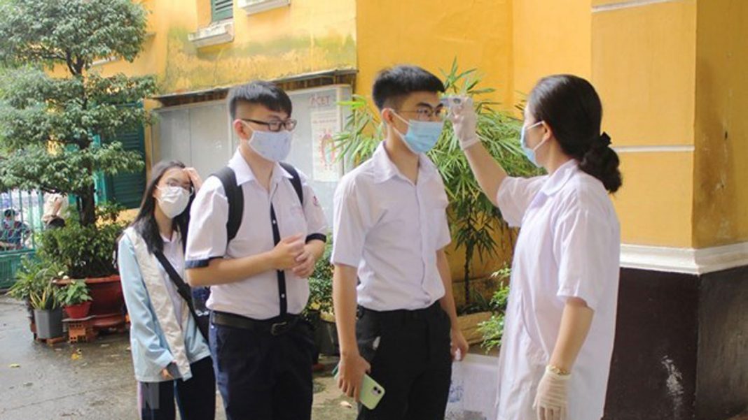 Students have their body temperature checked – PHOTO: VNA