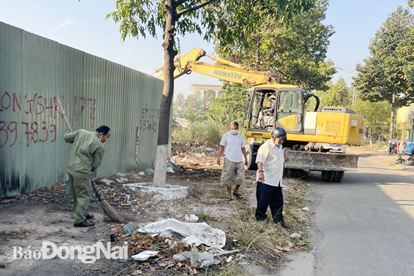 Lực lượng chức năng dọn rác thải trên vỉa hè tại các khu dân cư ở P.Bửu Long (TP.Biên Hòa)