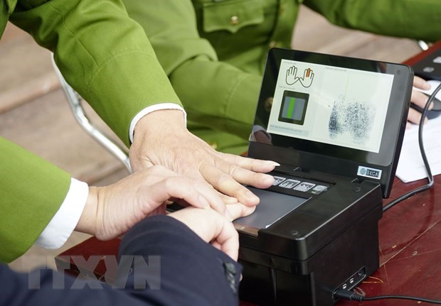 Taking fingerprint samples to make chip-based ID card.