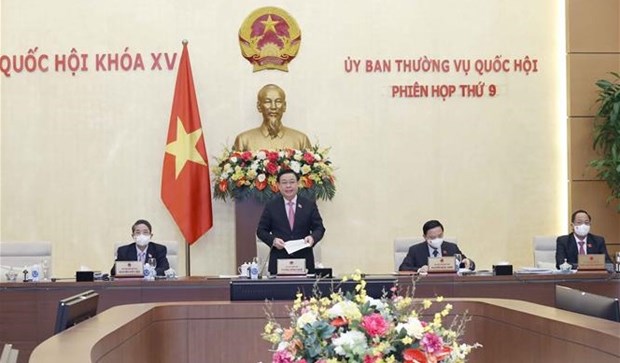 NA Chairman Vuong Dinh Hue (standing) addresses the 9th sitting of the NA Standing Committee on March 10. 