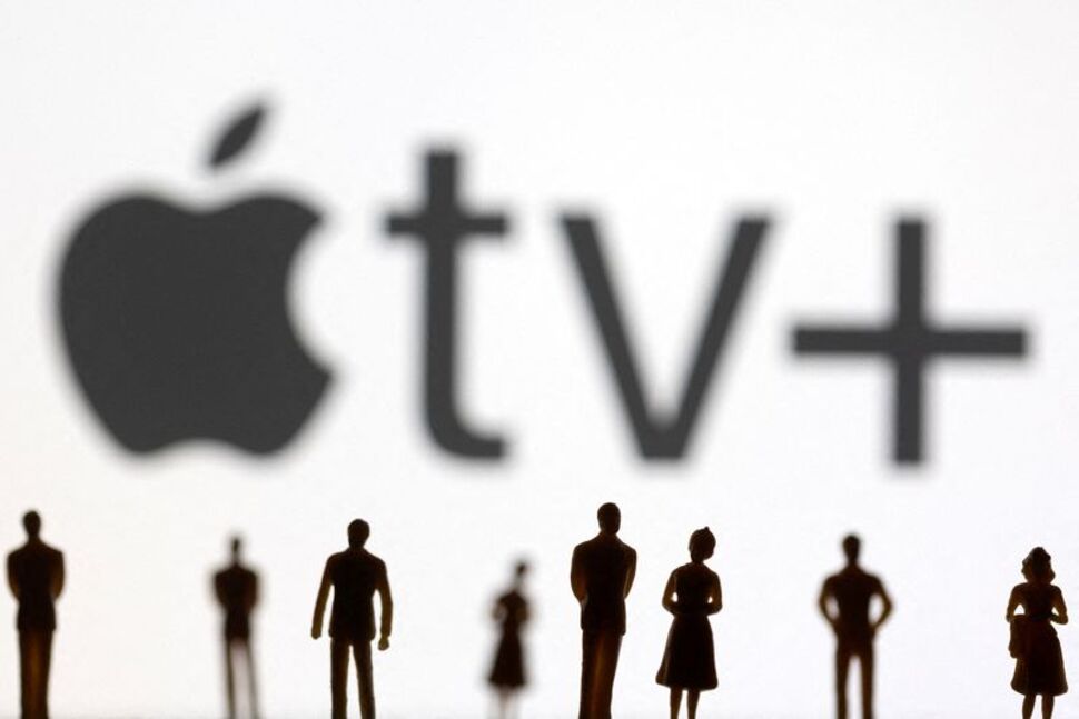 FILE PHOTO: Toy figures of people are seen in front of the displayed Apple TV + logo, in this illustration taken January 20, 2022.