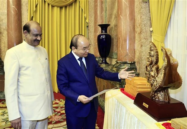 President Nguyen Xuan Phuc (R) presents a souvenir to Speaker of the Indian the lower house Om Birl.