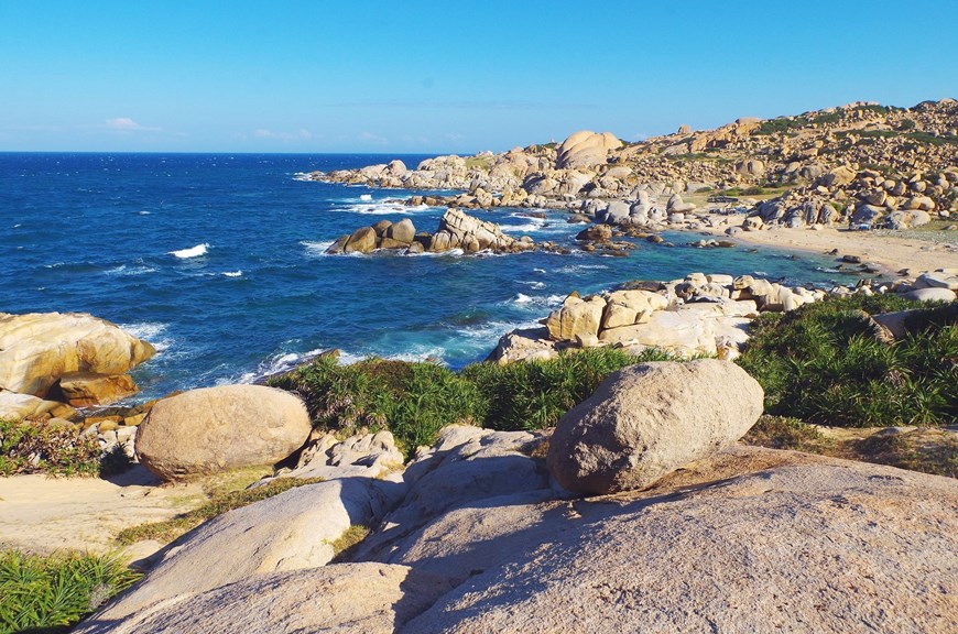 At the foot of the mountain is a primitive, beautiful, white sand beach with rocky cliffs and clear, blue water. 