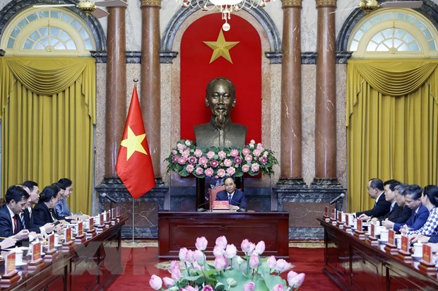 President Nguyen Xuan Phuc (C) at his reception for Minister and Chairwoman of the Presidential Office of Laos Khemmani Pholsena.