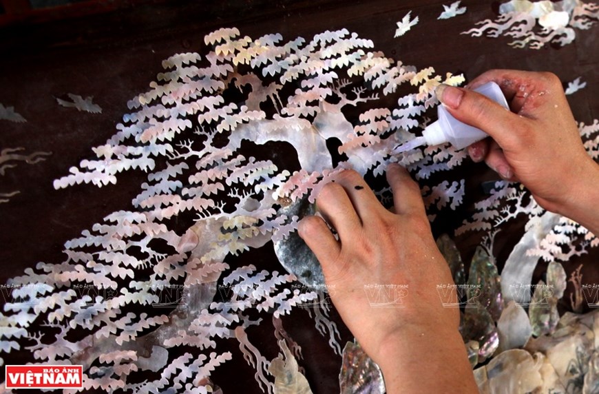 The nimble hands of mosaic artisans in Chuon Ngo craft village create unique images.