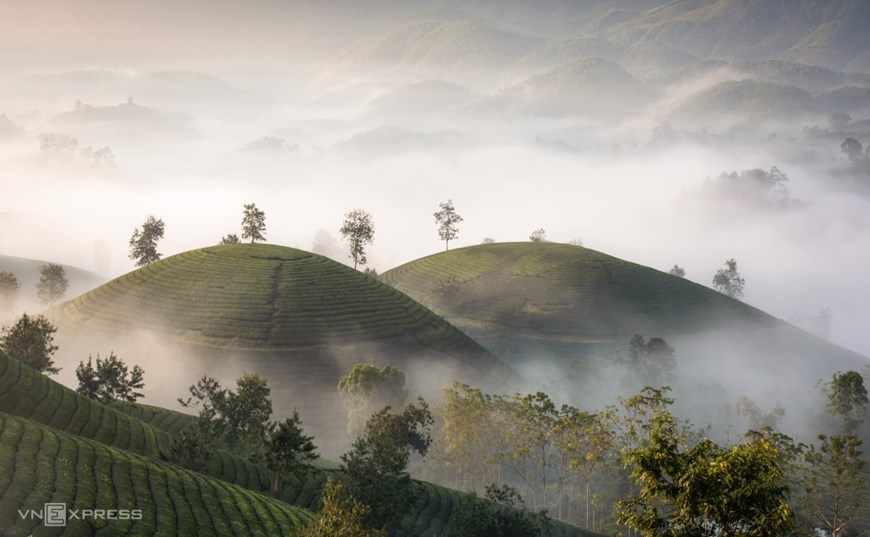 The fog lingers around the top during the transition from autumn to winter.