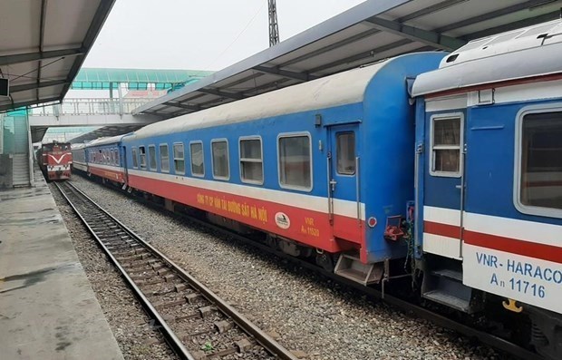 A Vietnam Railways train pasts by a local train station – PHOTO: VNA
