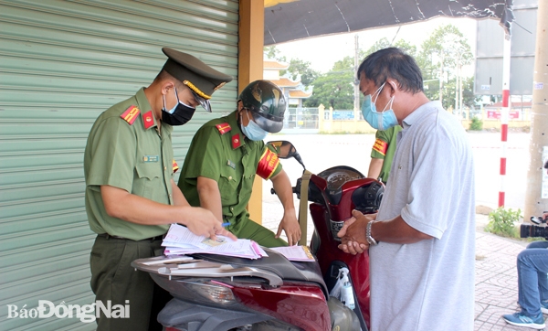 Cán bộ Công an TP.Biên Hòa lập biên bản xử phạt vi phạm hành chính một trường hợp vi phạm quy định về phòng, chống dịch bệnh Covid-19 vào tháng 7-2021