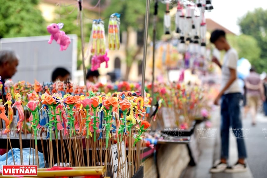 Toy figurines are sold on the Ho Guom pedestrian street during weekend. 