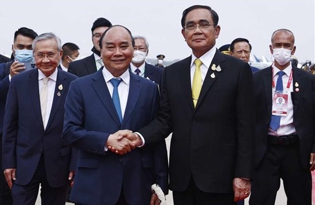 Thai Prime Minister Prayut Chan-o-cha (R) welcomes President Nguyen Xuan Phuc at Don Mueang International Airport in Bangkok on November 16. 