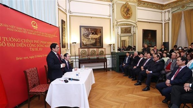 PM PhamMinh Chinh speaks at a meeting with Vietnamese community in Belgium on December 13. 