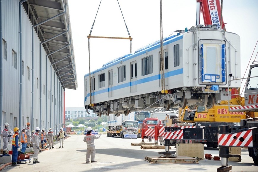 Installing the first wagon of train No. 2 of the Ben Thanh - Suoi Tien metro line No 1 onto a railway track at Long Binh Depot in Thu Duc city, Ho Chi Minh City. 